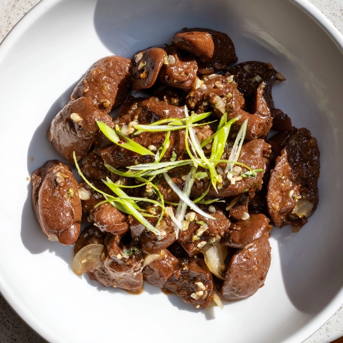 Savory Adobong Atay ng Manok simmers in a rich, garlicky soy-vinegar sauce, ready to serve.