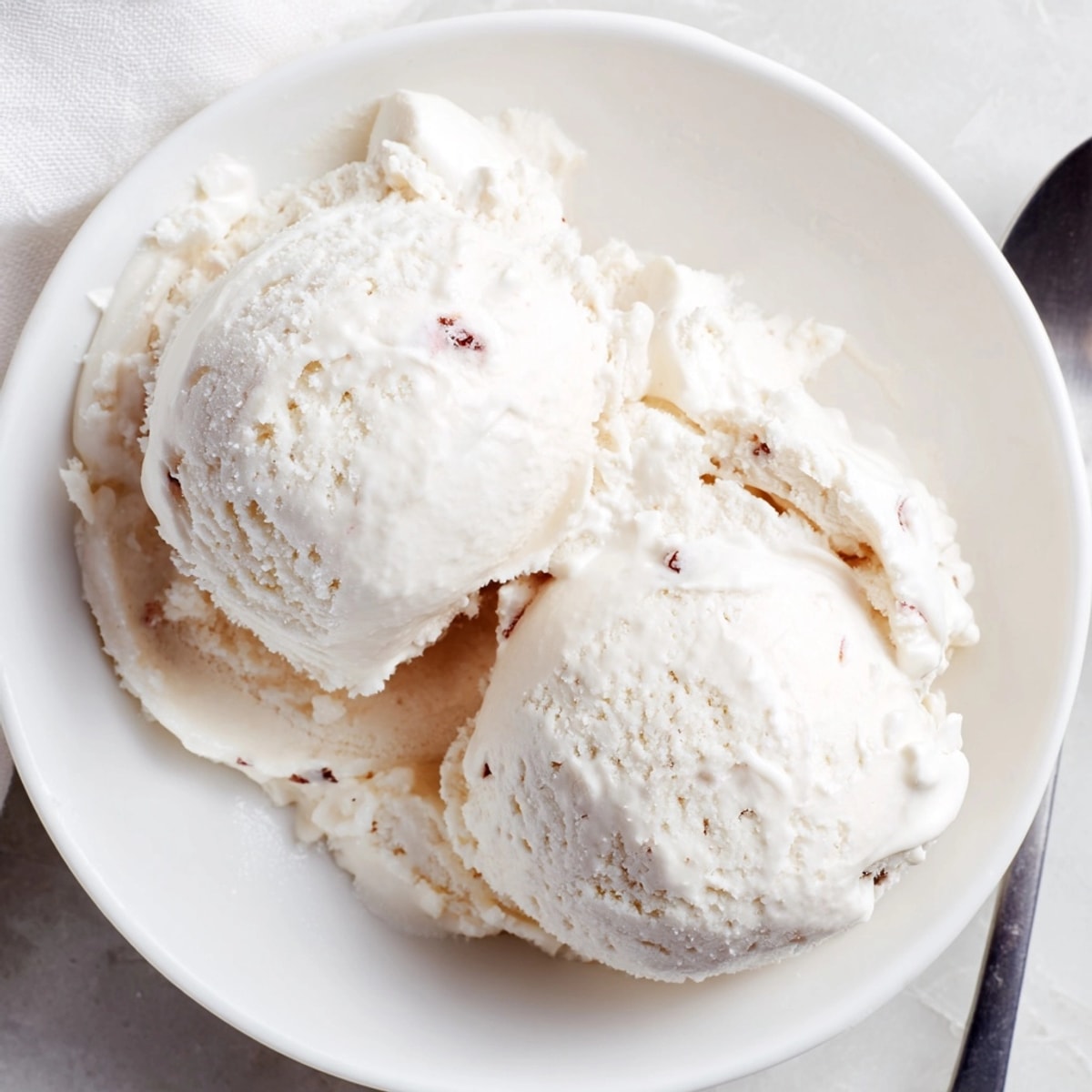 Velvety smooth Cottage Cheese Ice Cream recipe, a healthier dessert alternative topped with granola.