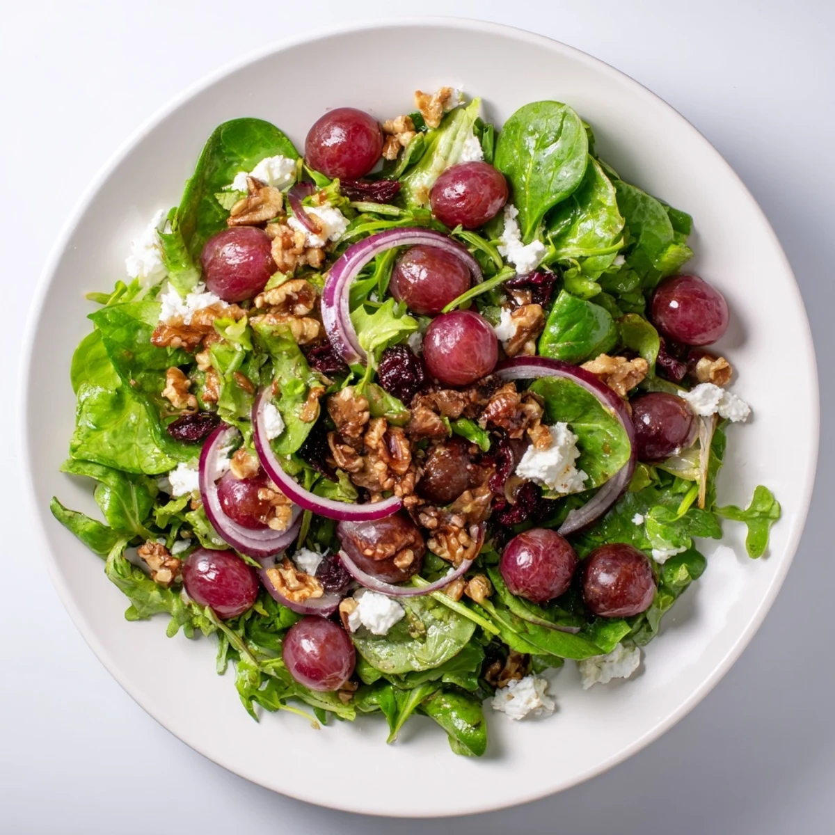 Vibrant Cranberry Walnut Salad: a refreshing mix of greens, cranberries, walnuts, and goat cheese.
