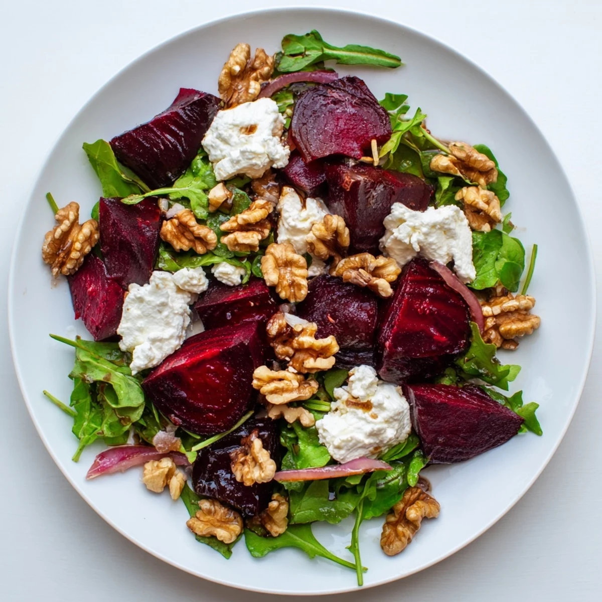Earthy Roasted Beet and Goat Cheese Salad with balsamic glaze and fresh, crisp greens.