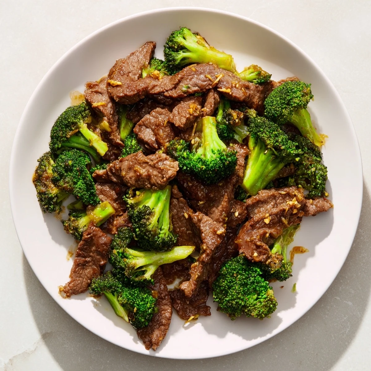 Tender beef and crispy broccoli swim in a savory sauce in this inviting beef and broccoli stir fry.