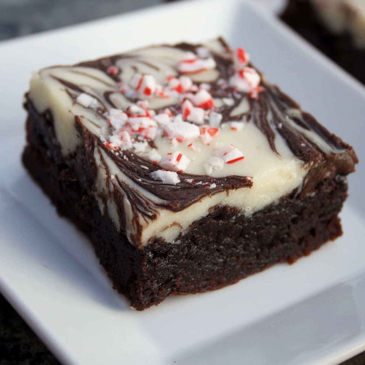 Delicious Peppermint Bark Chocolate Brownies, ready to eat, showing a peppermint candy topping with a chocolate base.