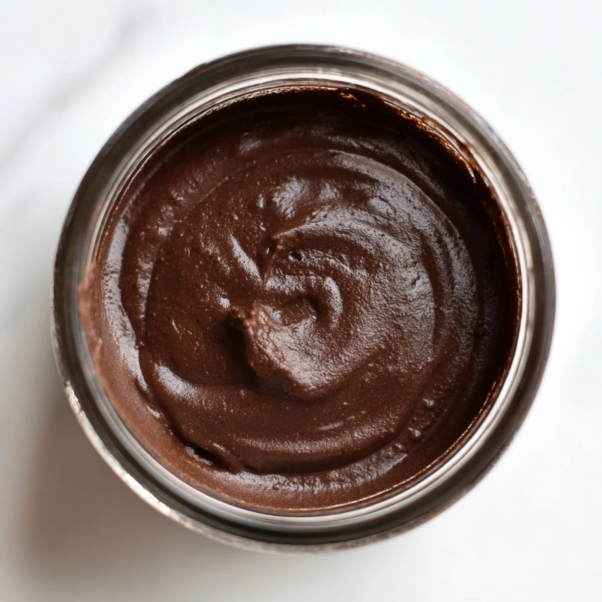 A jar of luscious homemade chocolate spread, ready to enjoy on warm toast.