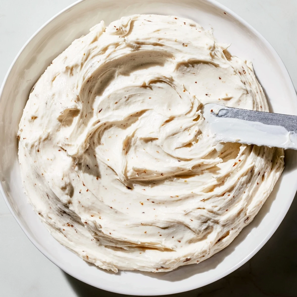 Fluffy Winter Frosting ready to spread, a soft, creamy delight for your homemade cake layers.