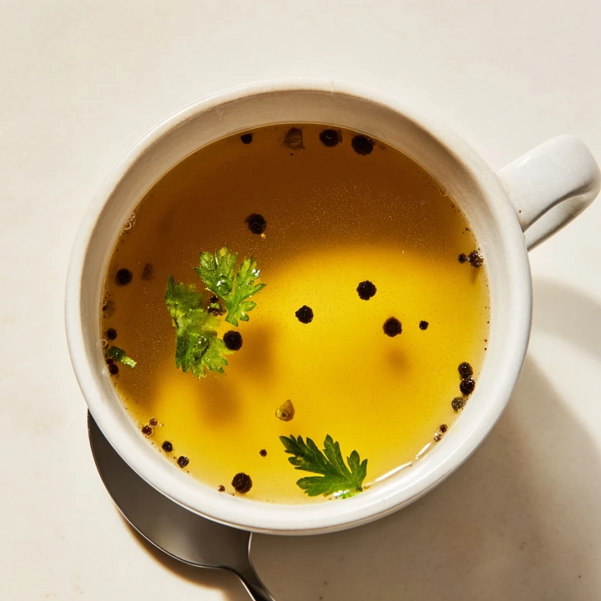 Enjoy a rich, golden serving of savory beef broth, ideally enjoyed hot with herbs.