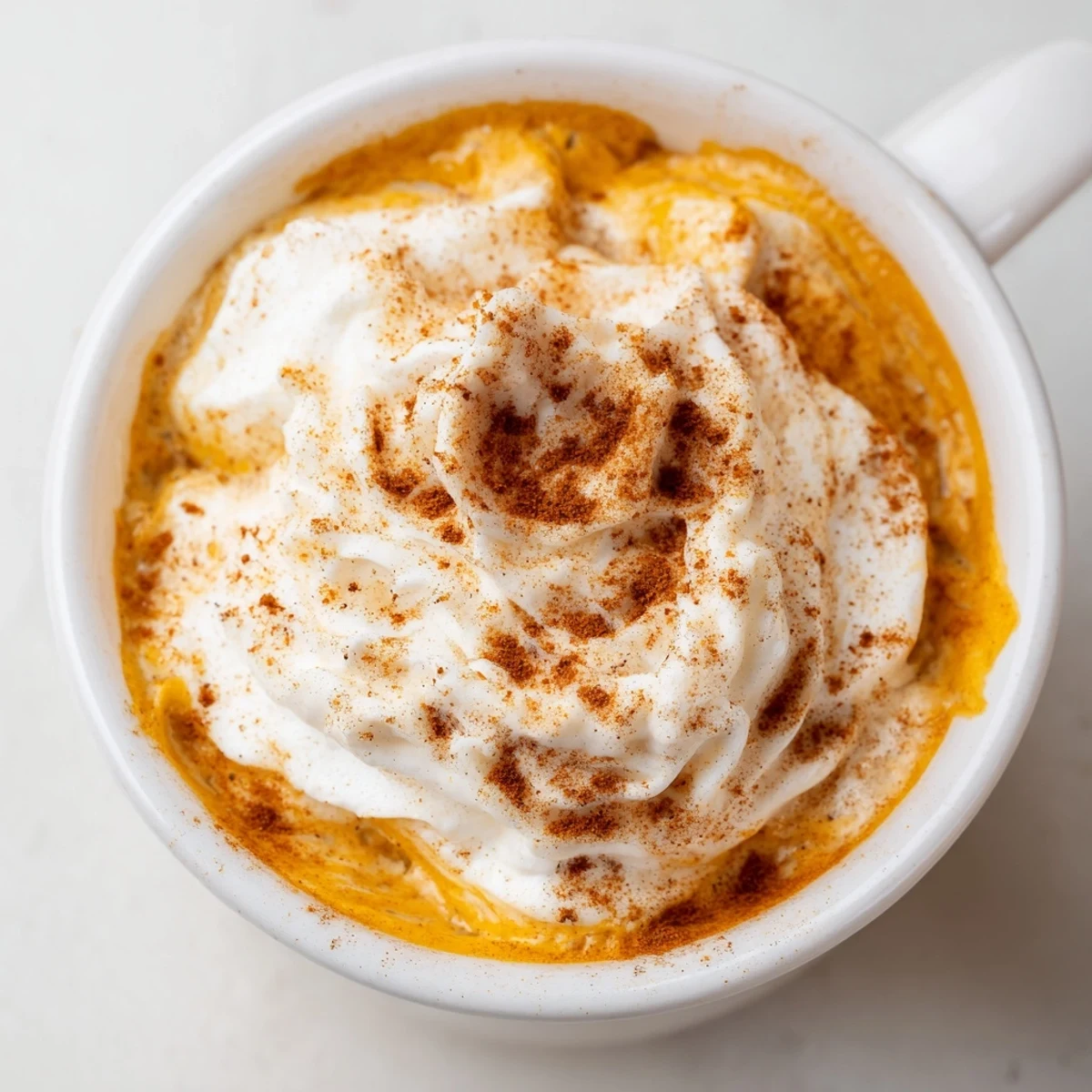 Enjoy a frothy Pumpkin Spice Latte made with pumpkin puree, espresso, and cozy autumn spices.