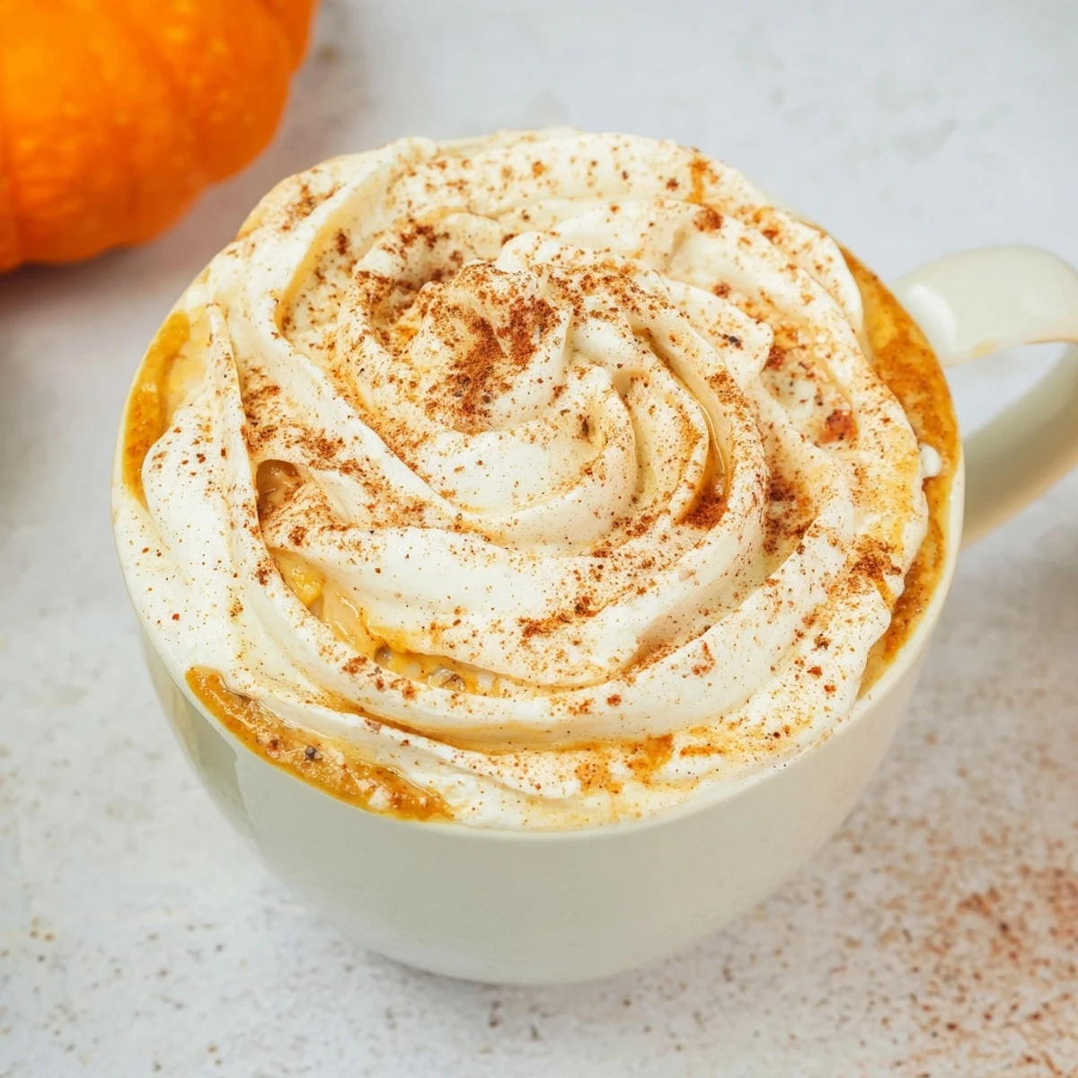 A warm and comforting homemade Pumpkin Spice Latte with rich spices and creamy texture in a glass.