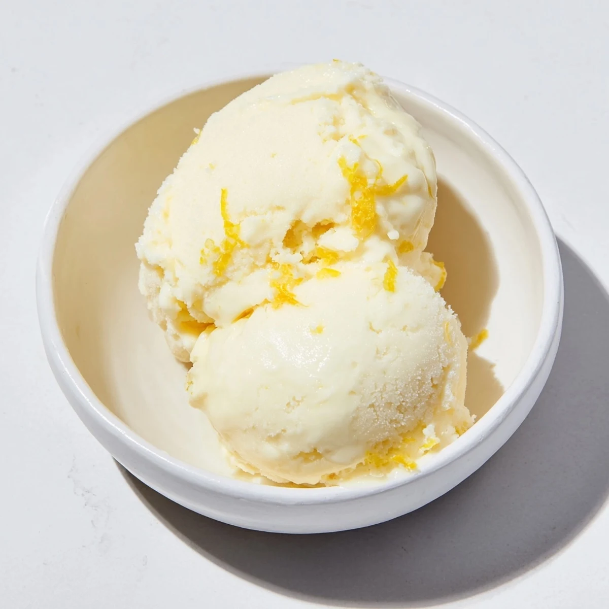 A vibrant scoop of lemon sorbet, a bright dessert with a perfect balance of sweet and tart.