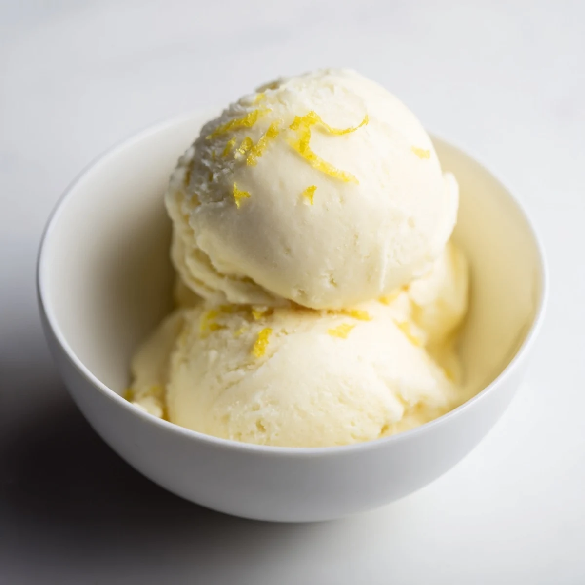 Cool and creamy lemon sorbet, a delightful vegan dessert served in a glass bowl.