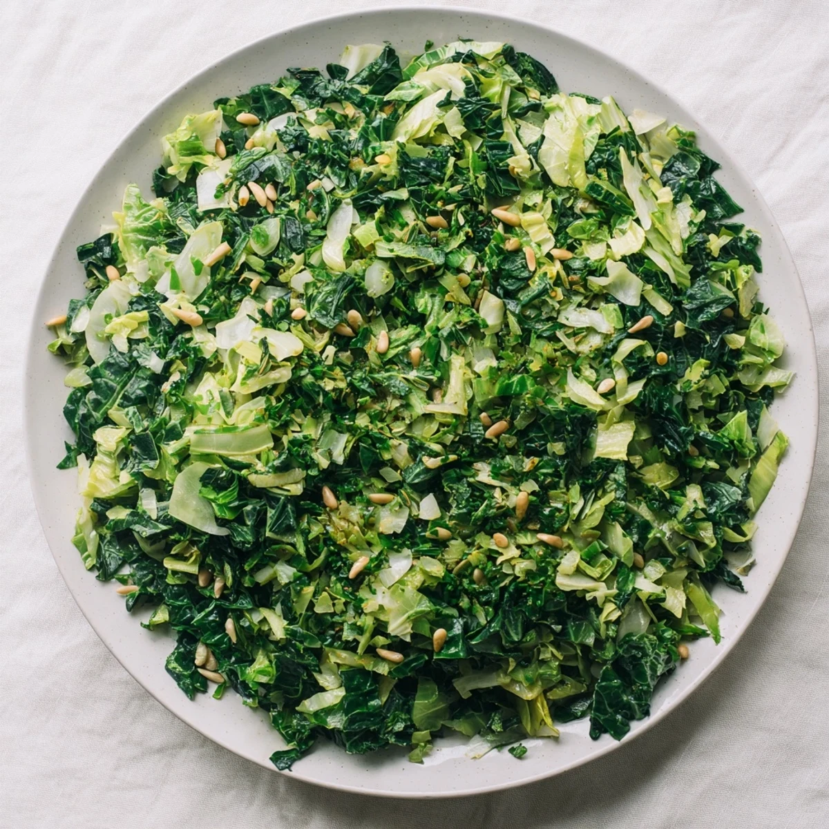 Sautéed winter greens with garlic and lemon, glistening in olive oil, a quick, healthy side dish.