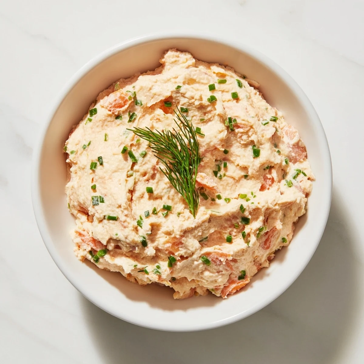 Creamy smoked salmon pâté spread on crackers, ready for an elegant appetizer, looks delicious.
