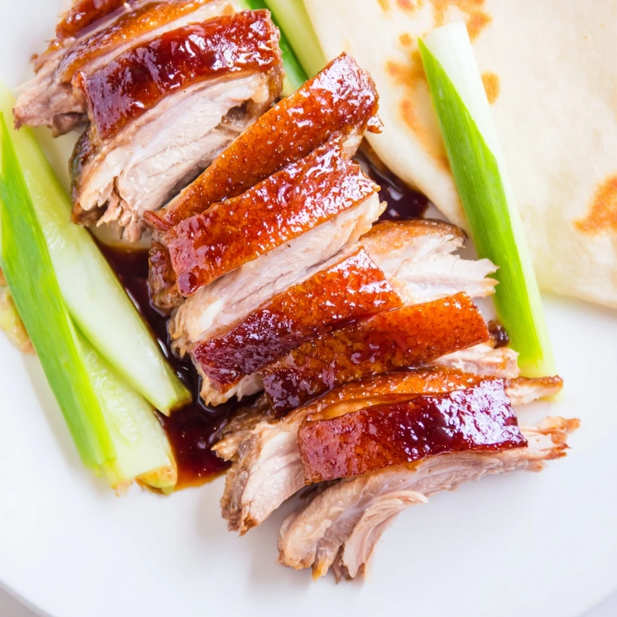 Golden-brown Crispy Duck with Hoisin glazed and ready to be sliced for appetizers.