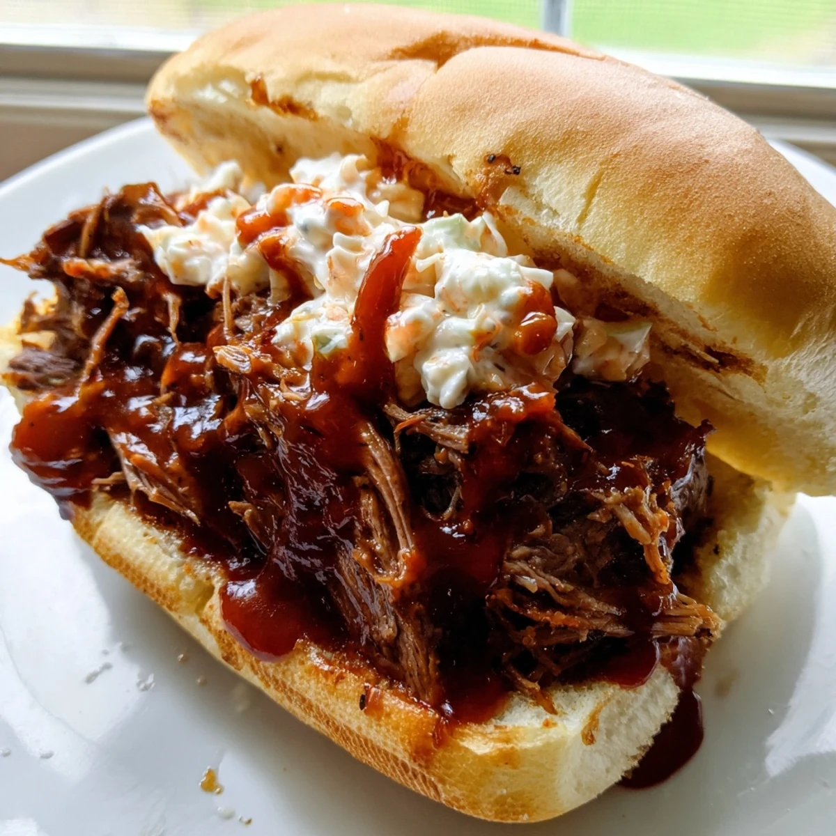 Golden toasted buns cradle juicy Slow Cooker Pulled Beef Sandwiches, garnished with creamy coleslaw for the ultimate lunch.