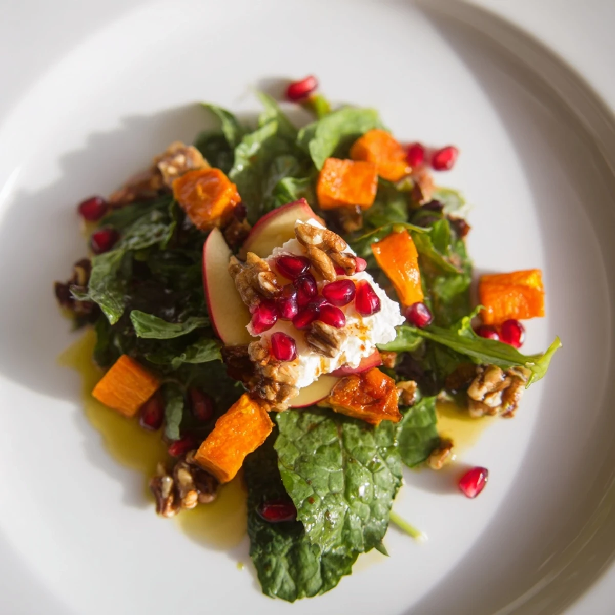 Hearty baby kale and arugula salad topped with toasted walnuts and bright pomegranate seeds, the Winter Salad Mix.