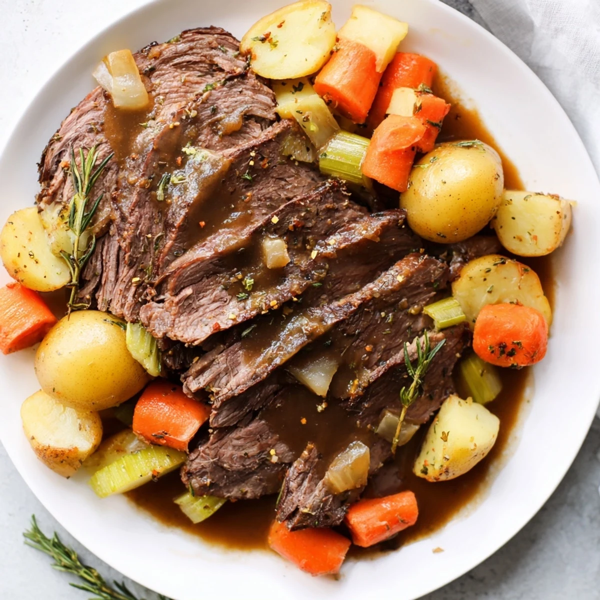 Slow Cooker Pot Roast with Savory Gravy over onions and carrots, steam rising from the tender meat.
