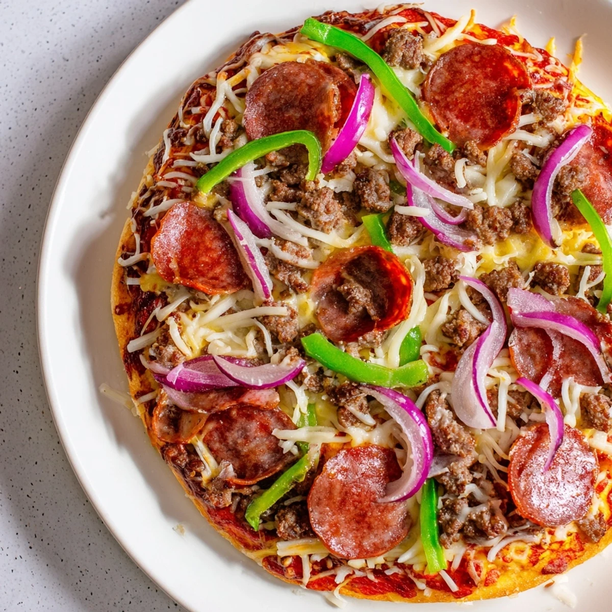 Slice of savory MVP Meat Lover Pizza on a white plate, served alongside a crisp green salad for dinner.