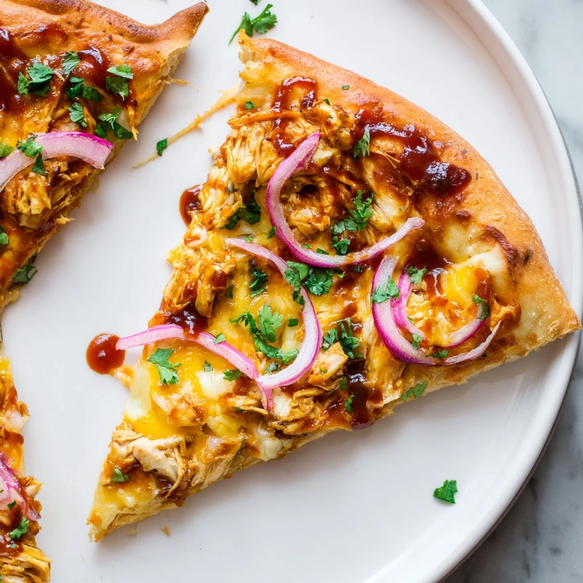 Freshly baked BBQ Chicken Pizza with Red Onion on a wooden board, melted cheese bubbling over a golden crust and smoky sauce.