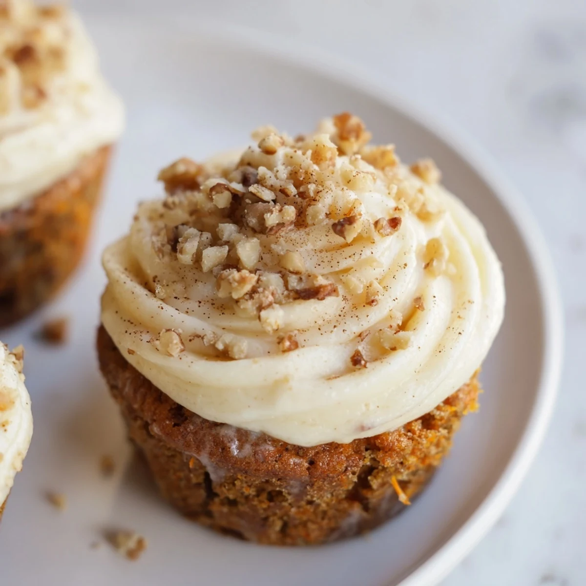 Freshly baked carrot cake cupcakes on a cooling rack, ready to be frosted and enjoyed.