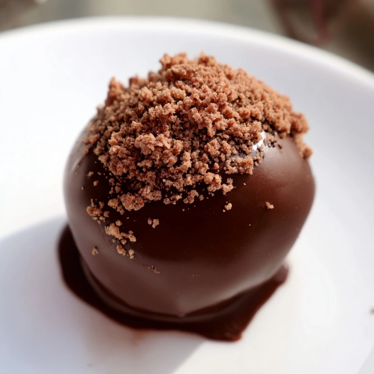 Close-up of glossy, round Irish Cream Truffles dusted with cocoa powder on a rustic wooden board.  