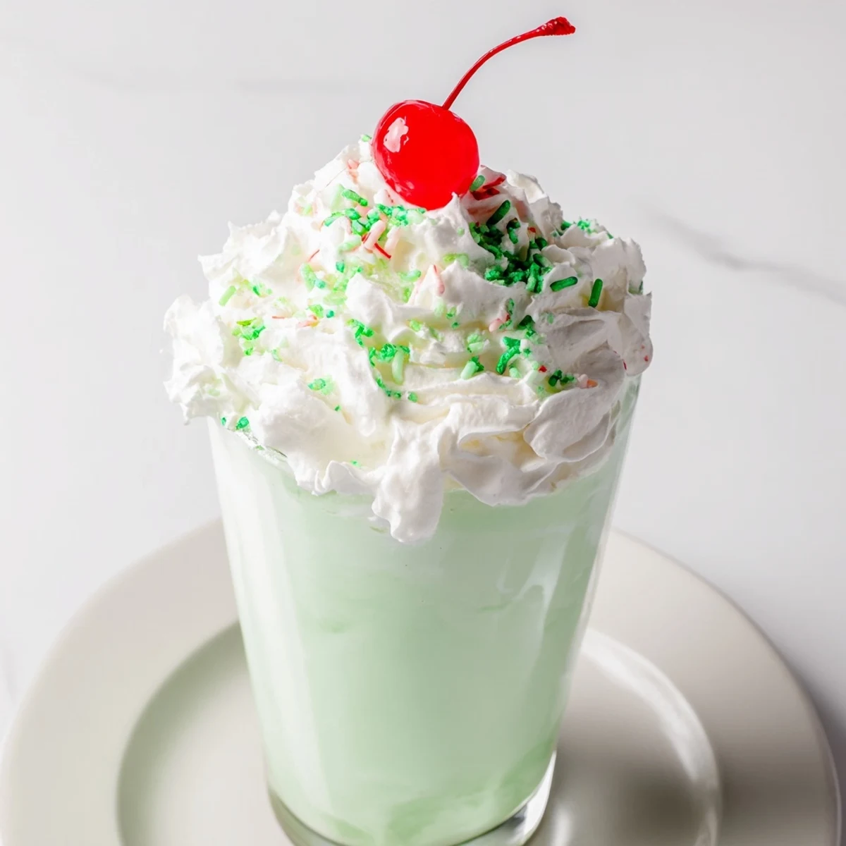 Frothy Homemade Copycat Shamrock Shake blended with vanilla ice cream and mint in a blender.