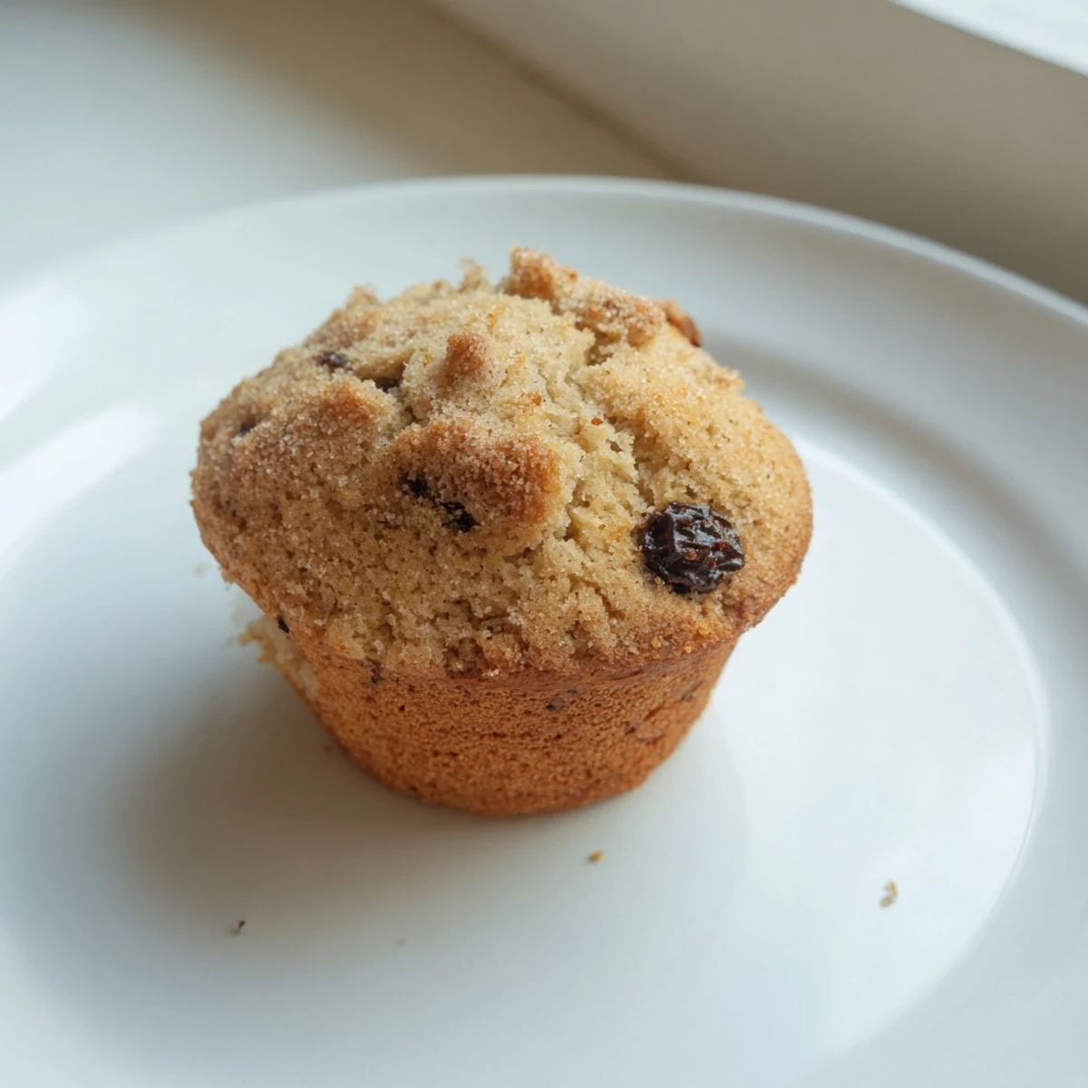 Golden brown Mini Irish Soda Bread Muffins studded with currants on a rustic wooden board.