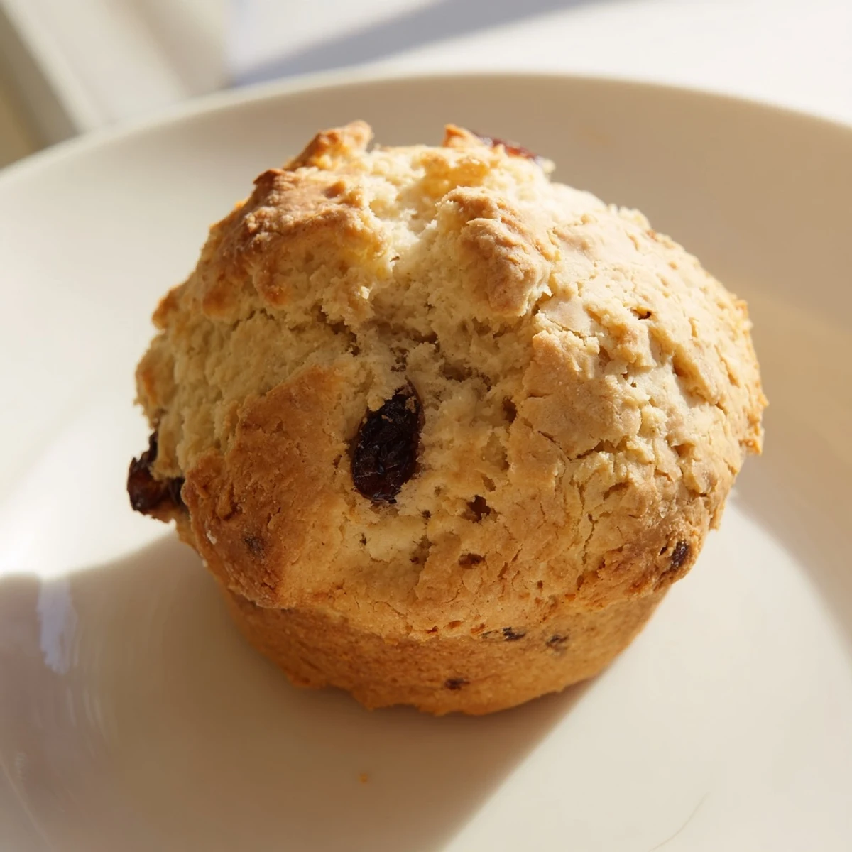 Close-up of fluffy Mini Irish Soda Bread Muffins with caraway seeds on a linen napkin.