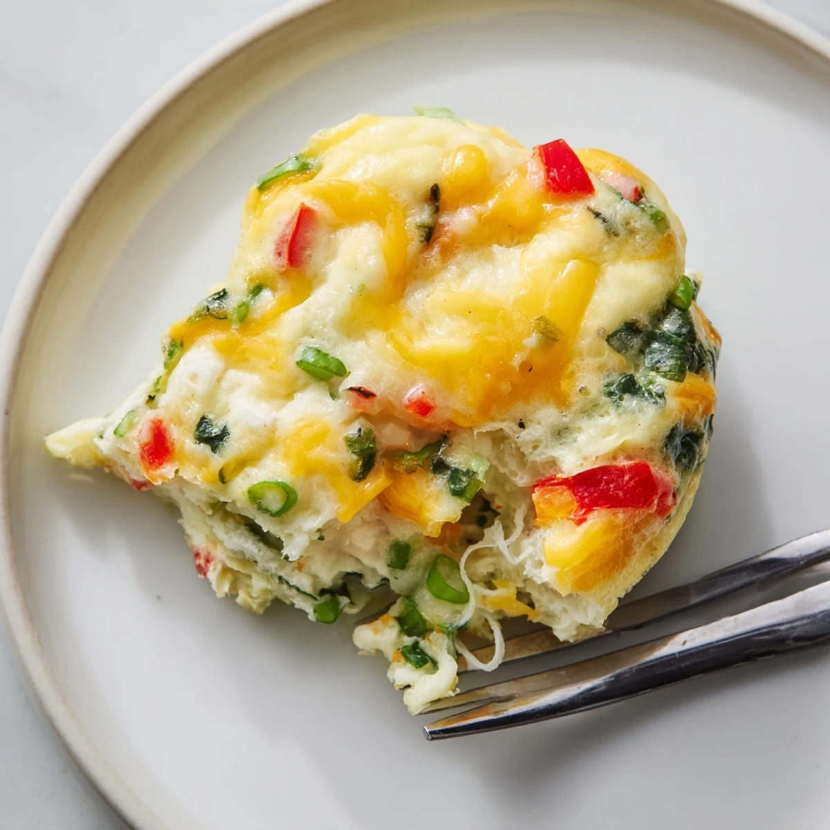 These savory cottage cheese egg bites are plated on a rustic wooden board, perfect for a quick healthy snack or a grab-and-go morning meal.