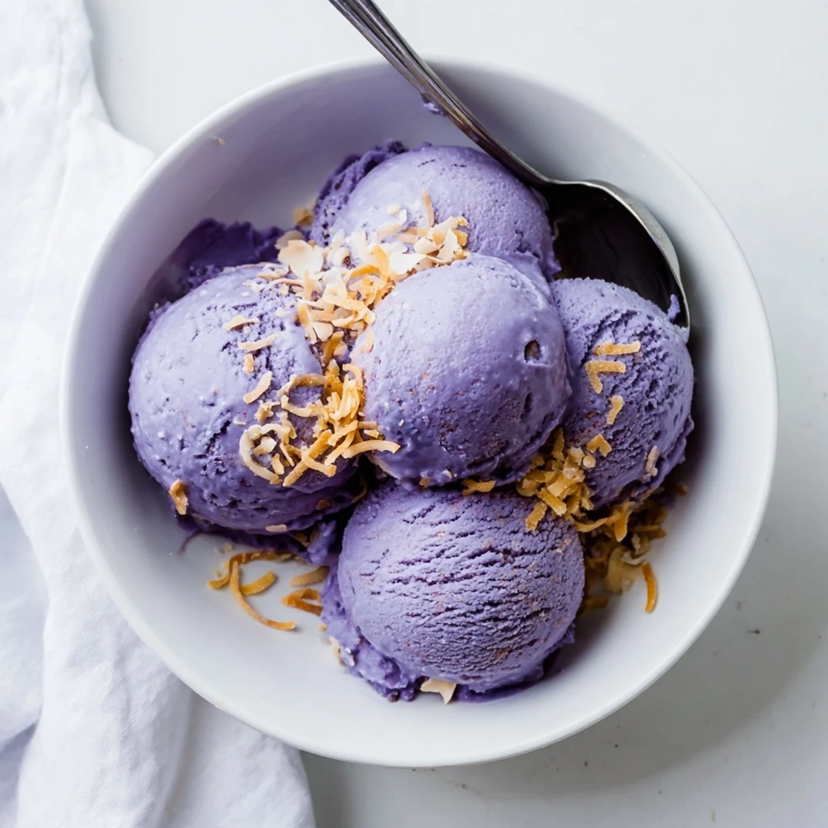 Close-up view of creamy Ube Ice Cream with rich purple color and a smooth, soft-serve texture.