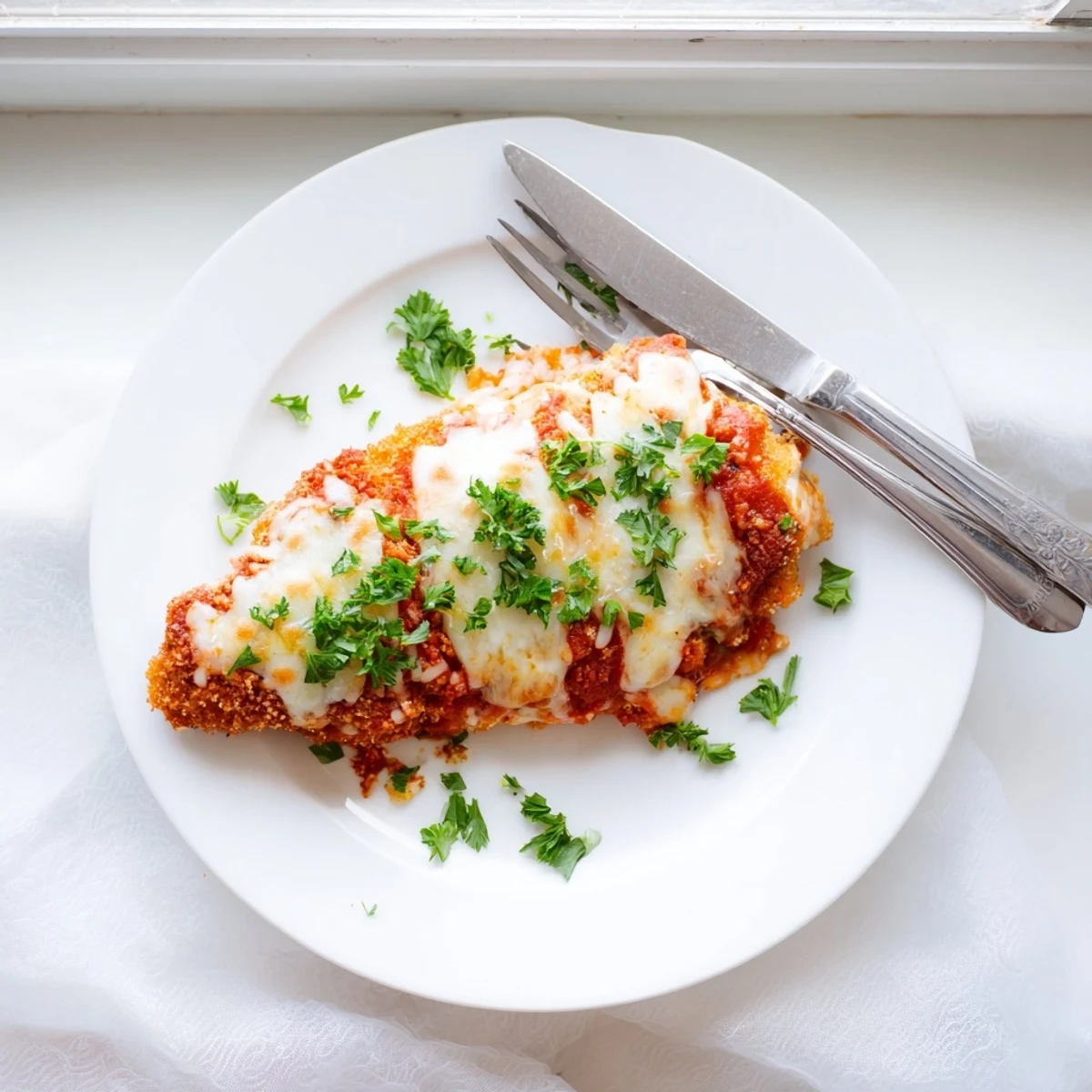 Golden crispy breaded chicken breasts topped with bubbling marinara and melted mozzarella cheese for Chicken Parmigiana.