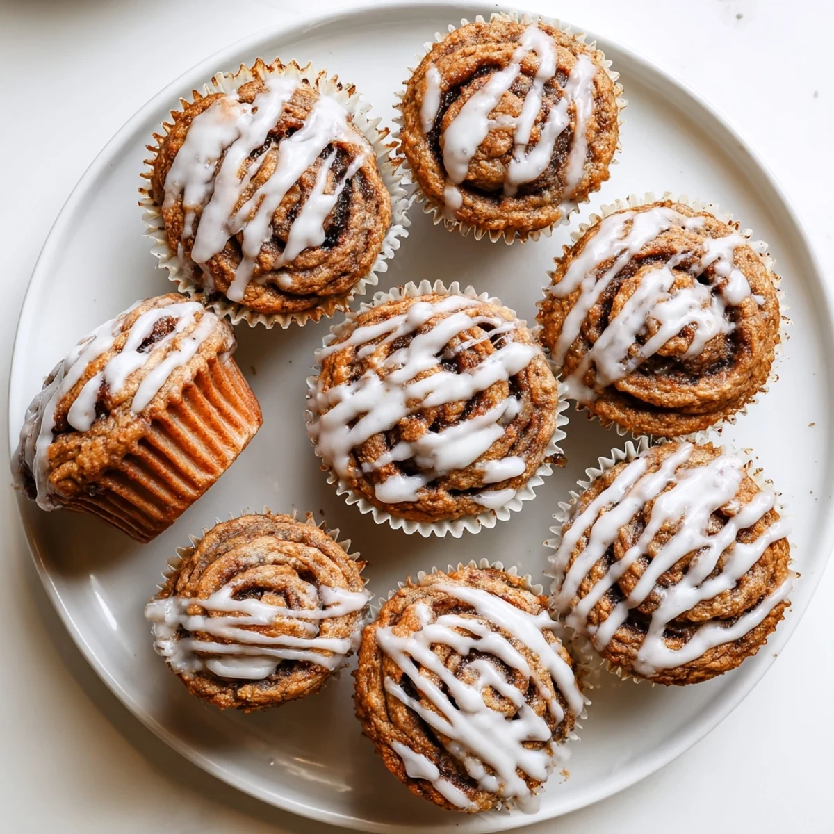 Fluffy high protein cinnamon roll muffins topped with sweet cinnamon sugar and glaze