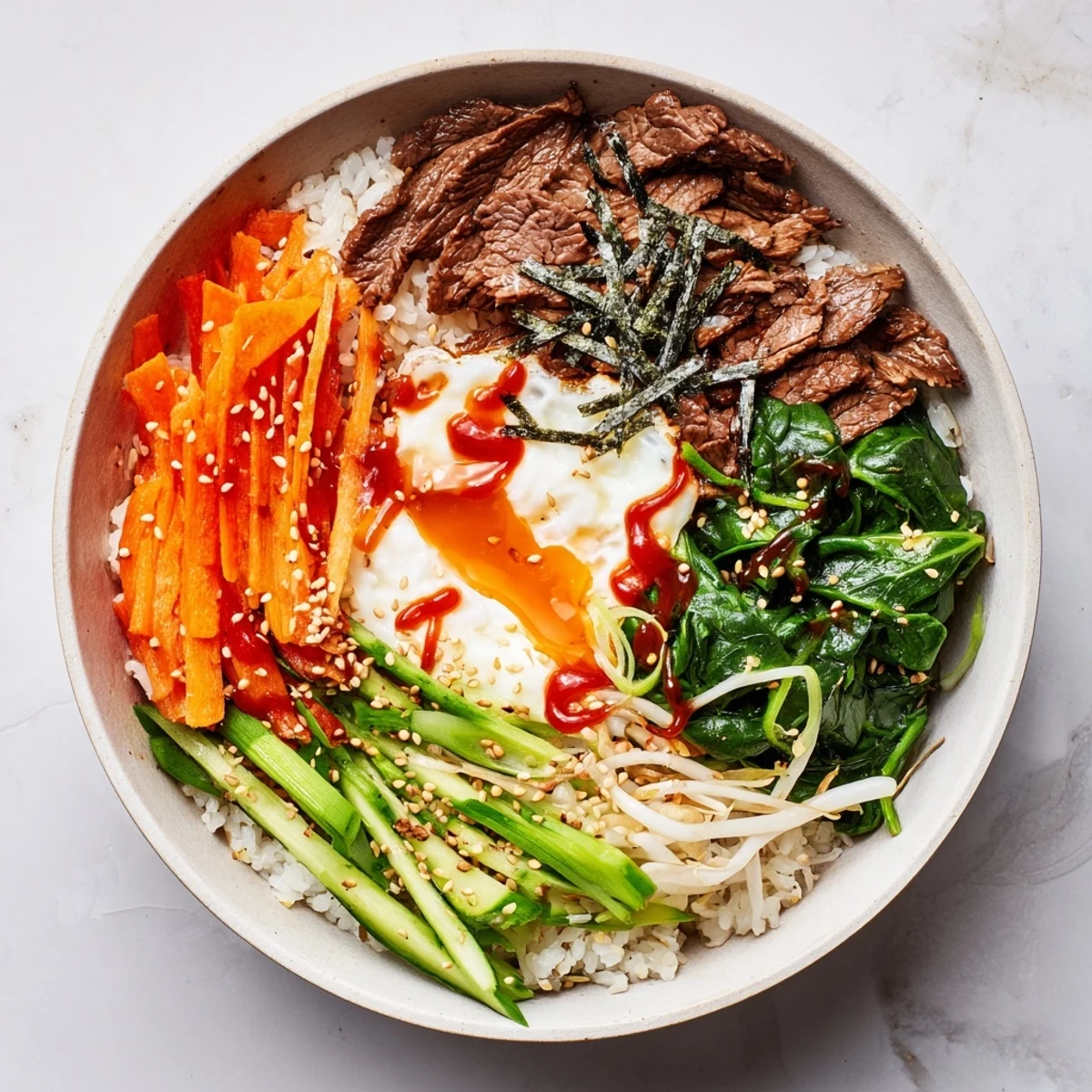 Savory marinated beef rice bowl with crisp vegetables and golden yolk center