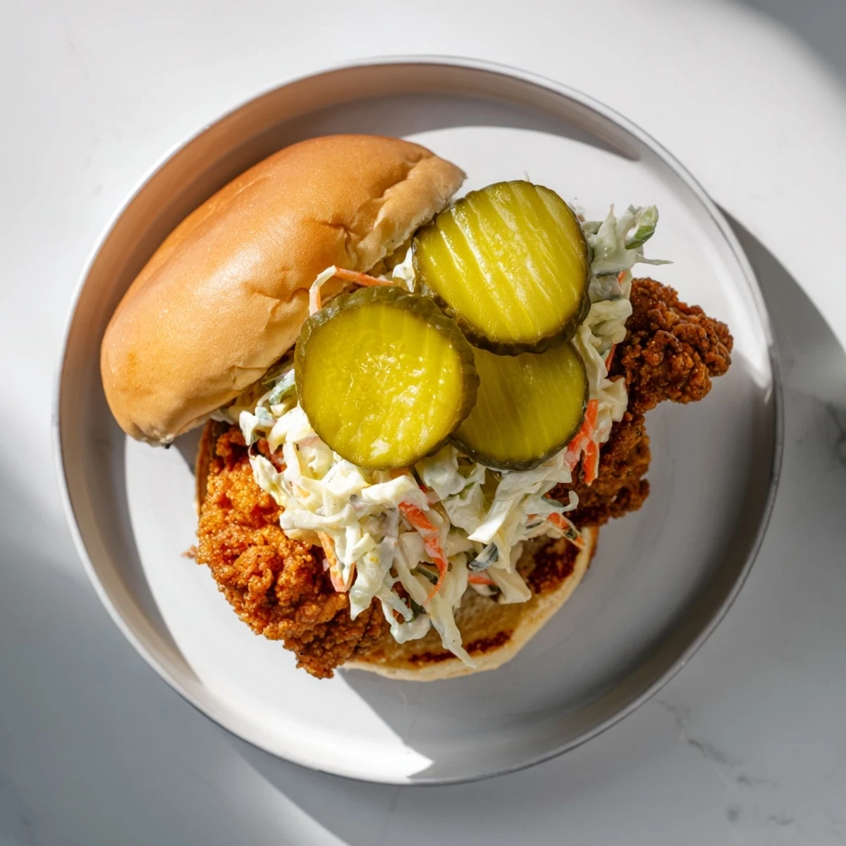 Juicy crispy Southern fried chicken burgers topped with tangy cabbage slaw and pickle slices
