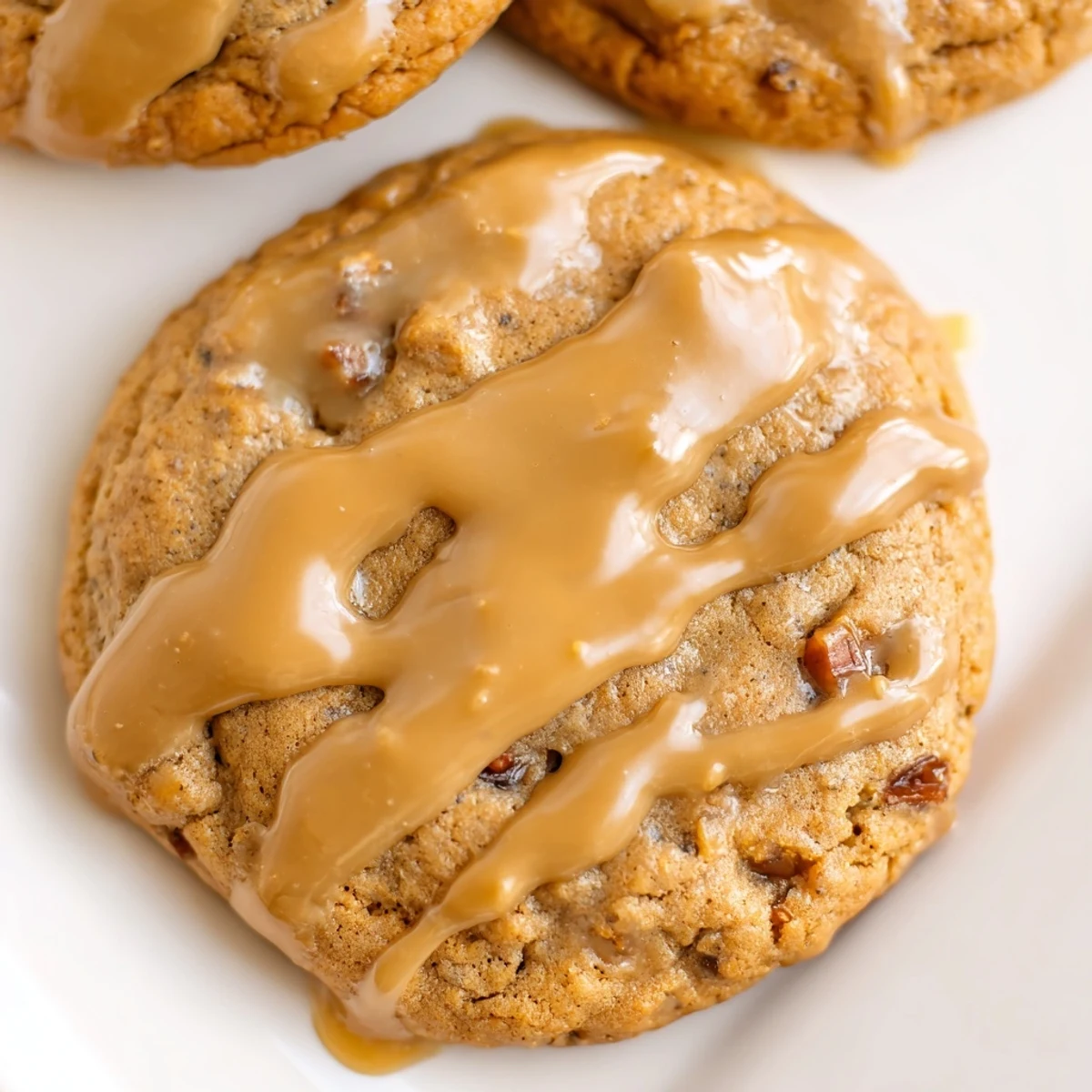 Freshly baked sticky toffee pudding cookies with sweet dates and caramel toffee glaze