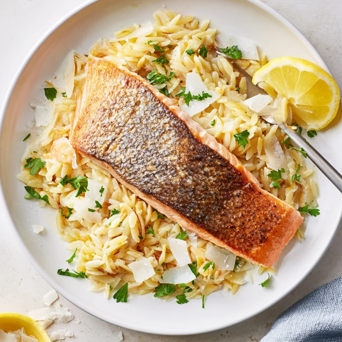One skillet salmon with lemon orzo featuring tender fish and bright citrus zest