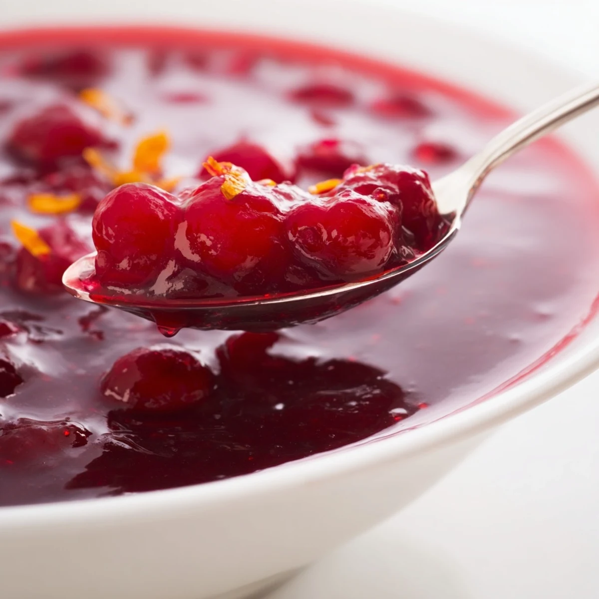 Smooth homemade cranberry sauce in a decorative glass mold, perfect for Thanksgiving holiday table