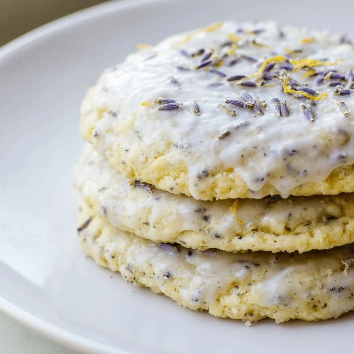 Soft lemon lavender cookies with golden edges arranged on a rustic white serving plate