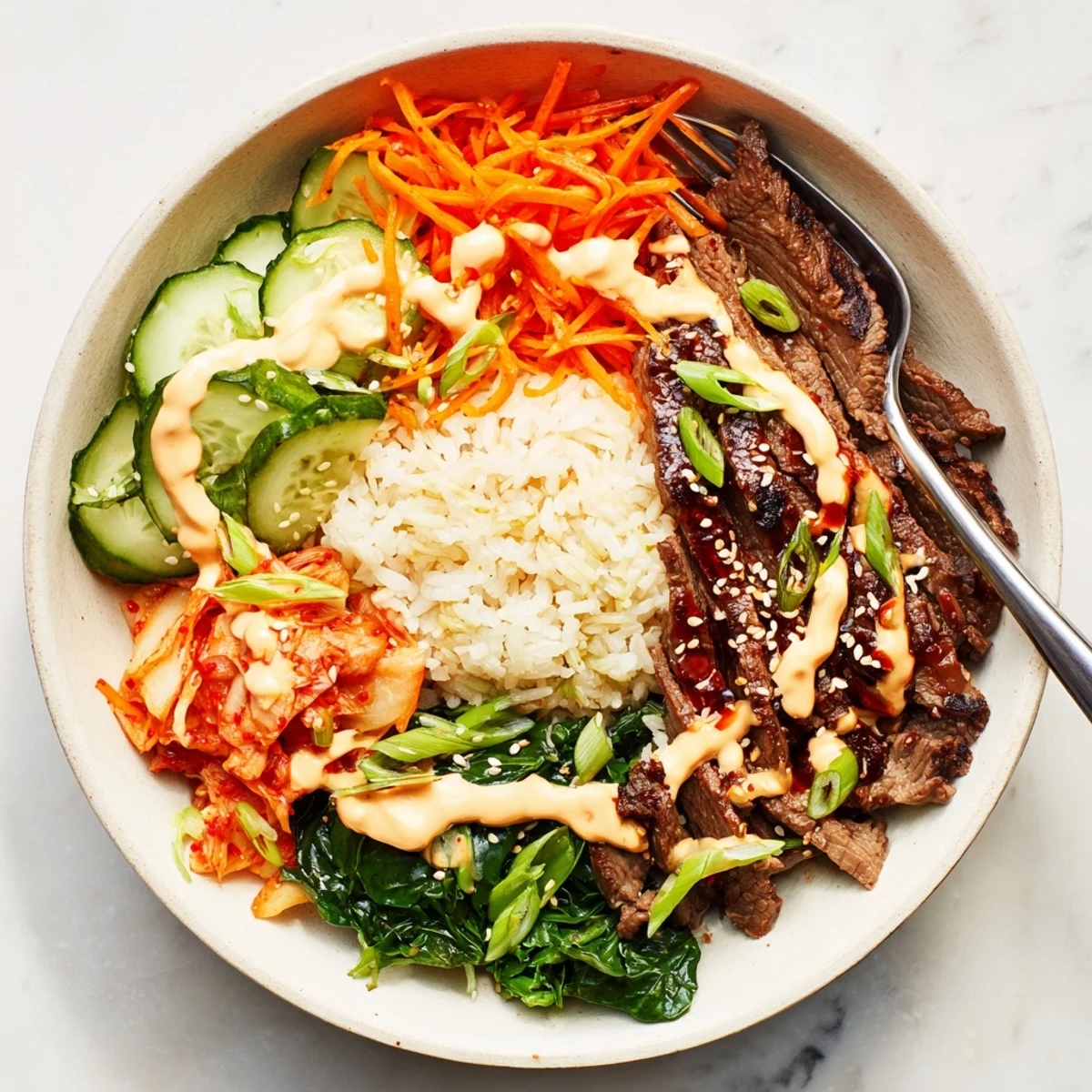 Korean BBQ steak rice bowls drizzled with spicy cream sauce over fluffy jasmine rice