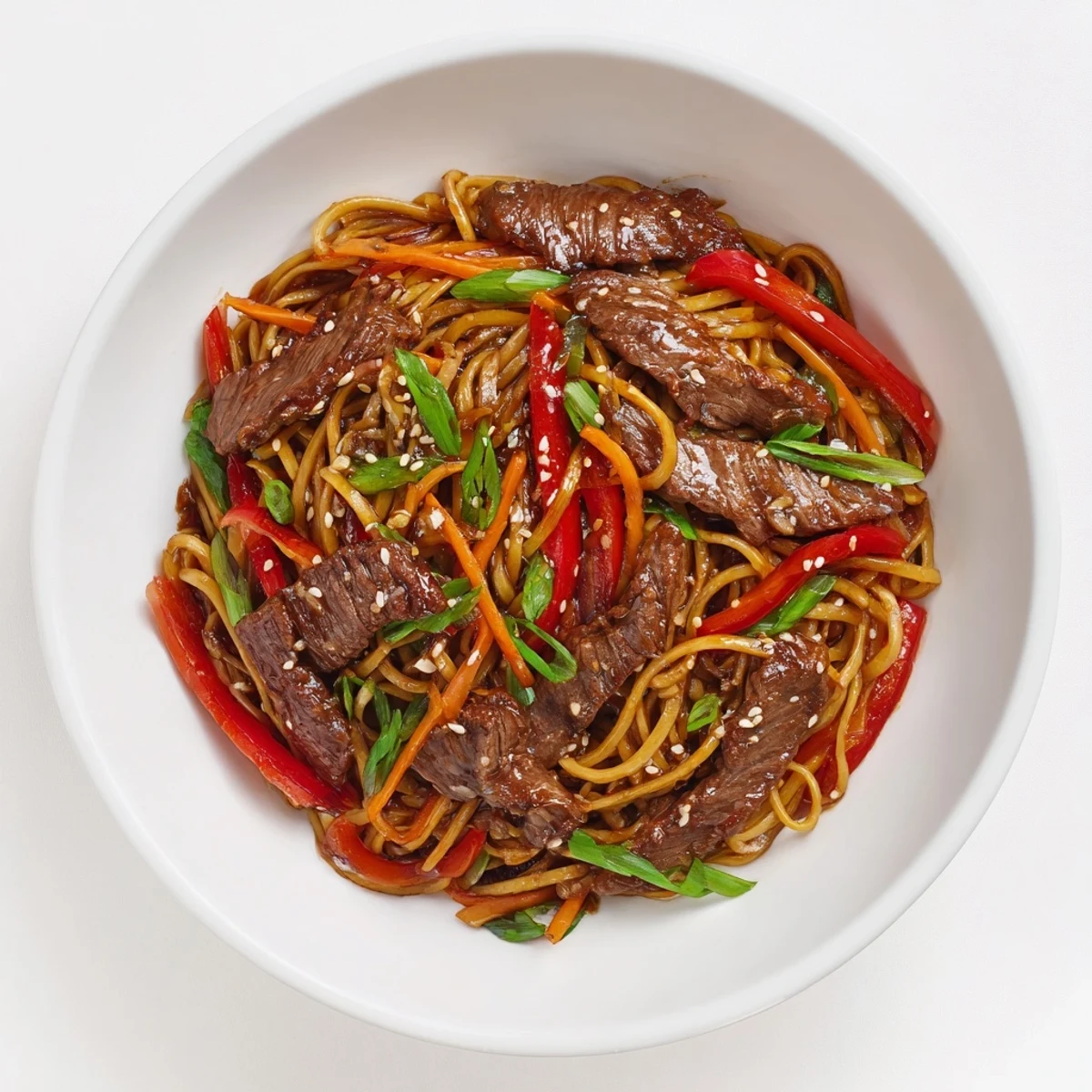 Sticky Beef Noodles glistening in hoisin sauce, tender beef, toasted sesame seeds