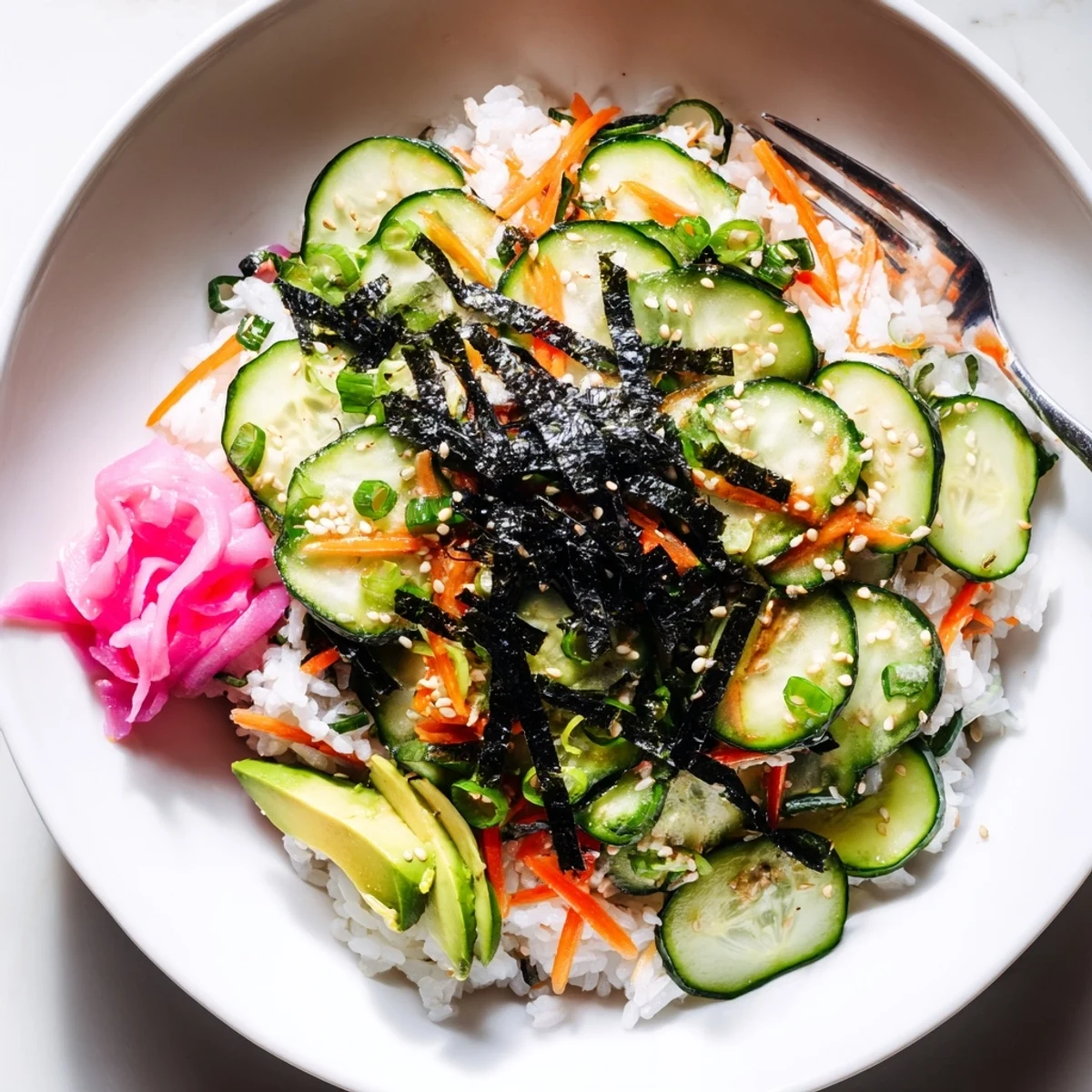 Chilled Sushi Cucumber Salad tossed with sushi rice, avocado, and toasted sesame