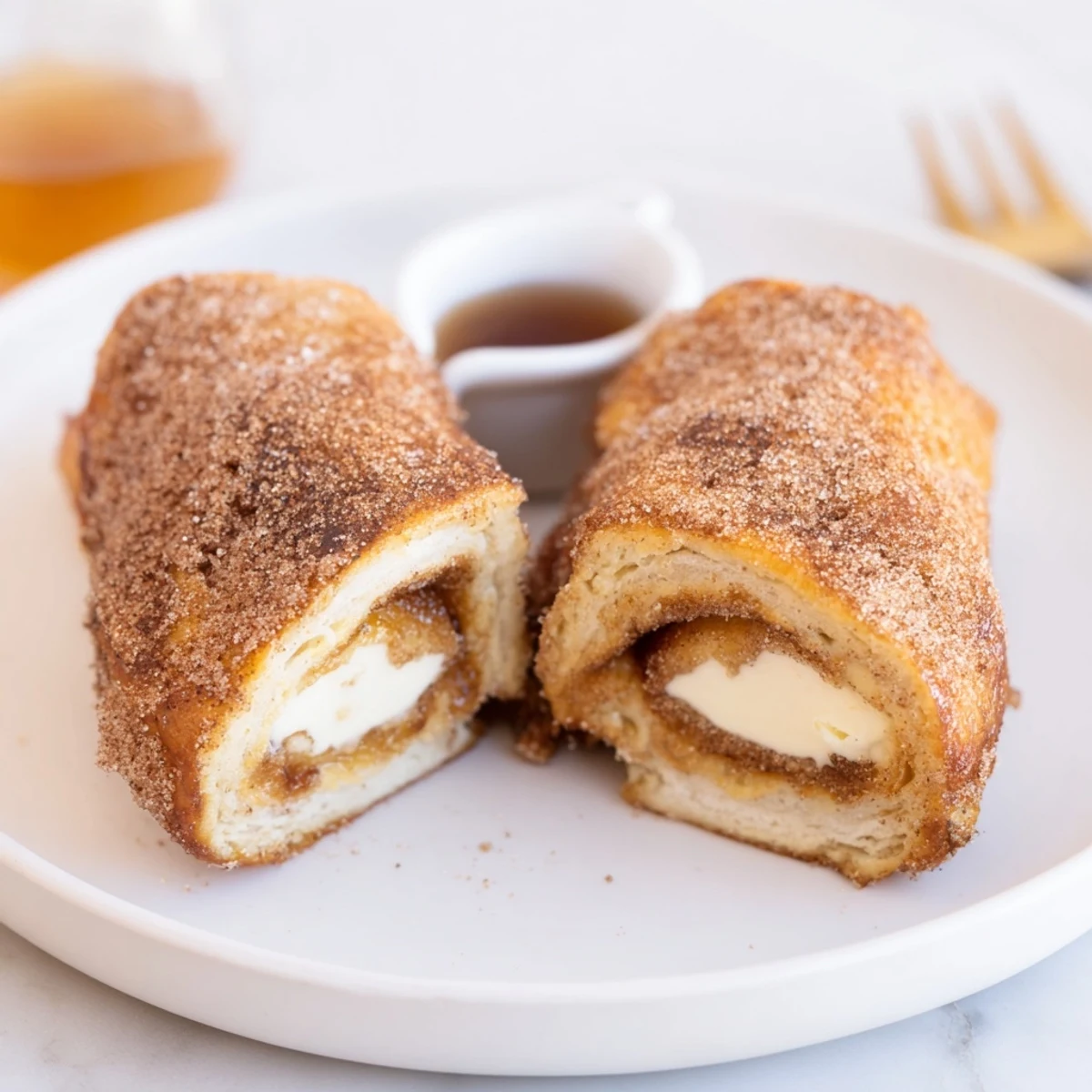 Warm Cinnamon Roll French Toast Roll Ups, golden edges, cinnamon sugar coating