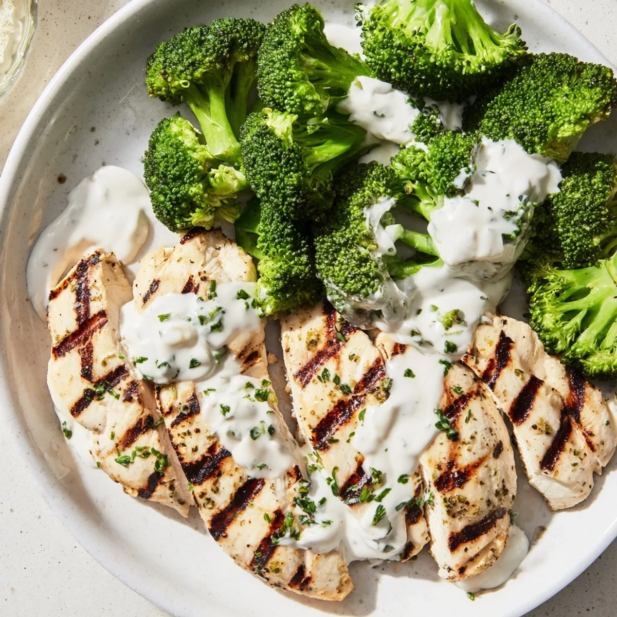 Protein-packed grilled chicken and crisp broccoli finished with tangy garlic yogurt sauce garnish