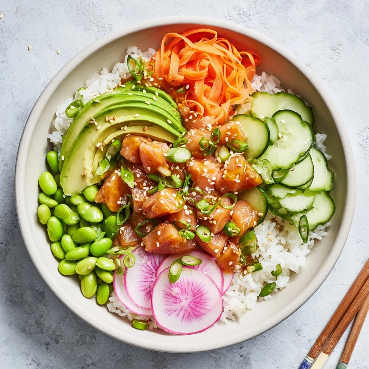 Fresh salmon and avocado poke bowl with colorful vegetables over seasoned rice