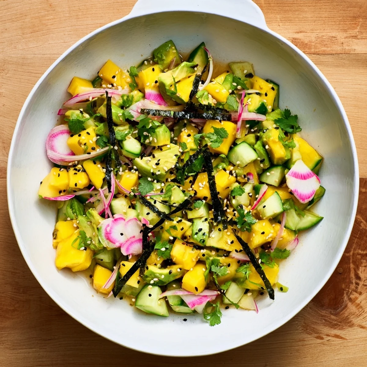 Vibrant Hawaiian-style poke bowl featuring creamy avocado cubes and sweet mango pieces with tangy soy dressing