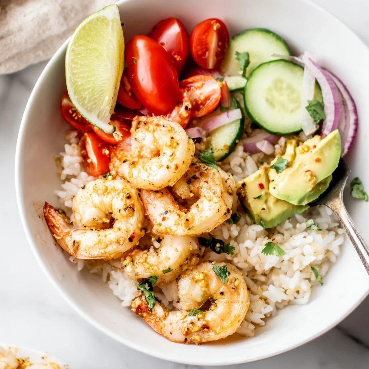 Colorful Garlic Shrimp Bowl Recipe Dinner garnished with cilantro, red onion, zesty lemon.