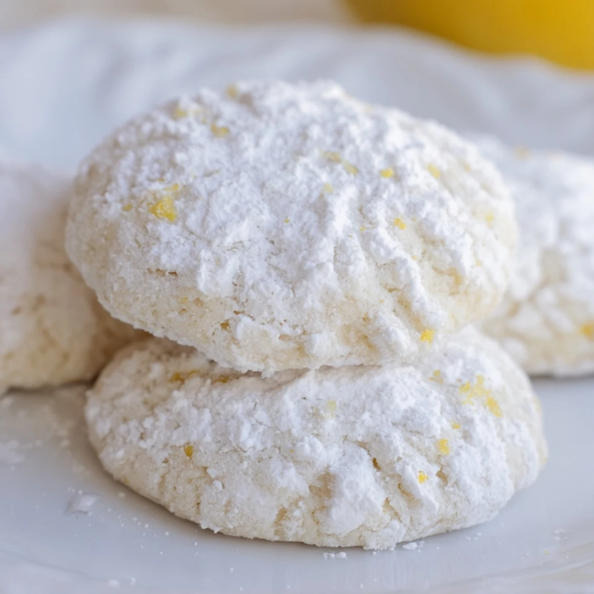 Chewy lemon pixie cookies with fresh lemon zest and powdered sugar coating