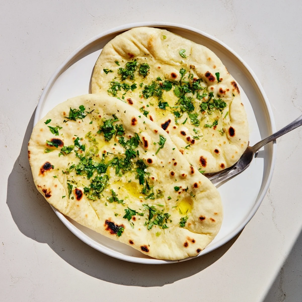 Warm homemade sourdough discard soft naan perfect for scooping up flavorful curries