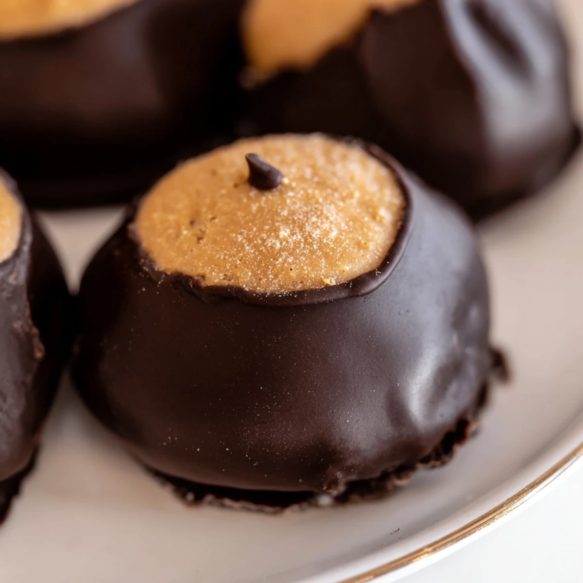 Golden peanut butter balls dipped in rich chocolate to make classic Buckeye Cookies from scratch