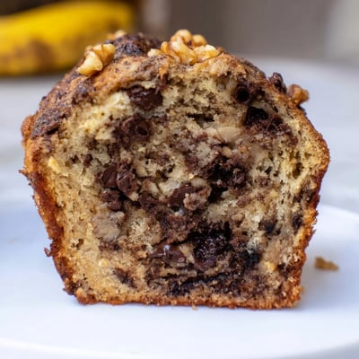 Moist Chocolate Chip Banana Bread Muffins paired with a steaming cup of morning coffee.