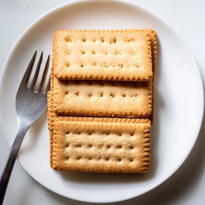 Crispy buttery Petit Beurre biscuits arranged on a rustic linen napkin