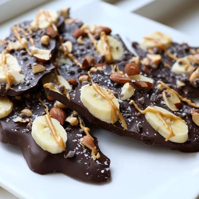 Viral chocolate banana bark with glossy melted dark chocolate and sliced ripe bananas